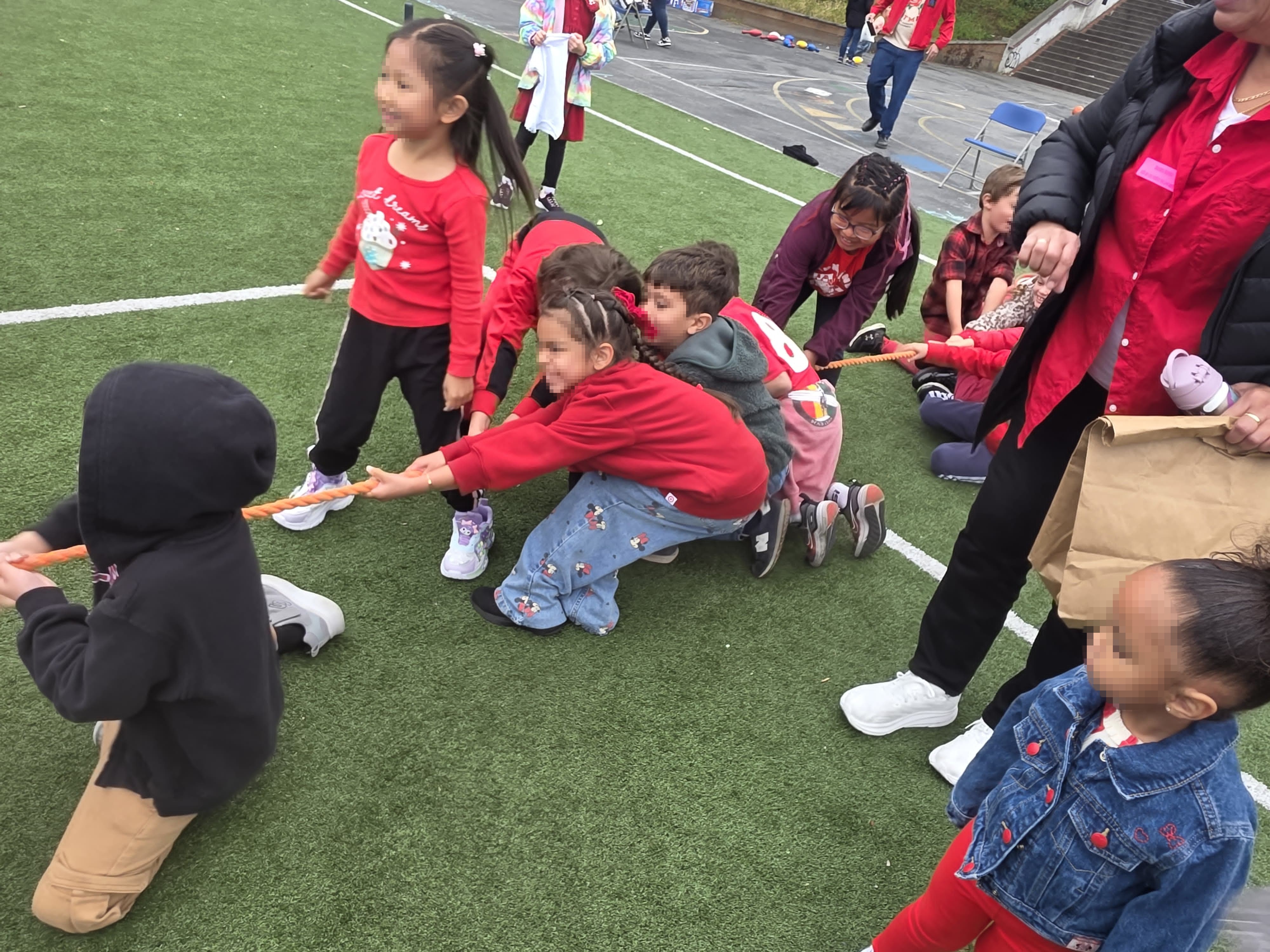 Students playing tug of war during Dia de los Ninos
